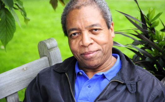 An older man sitting on a park bench