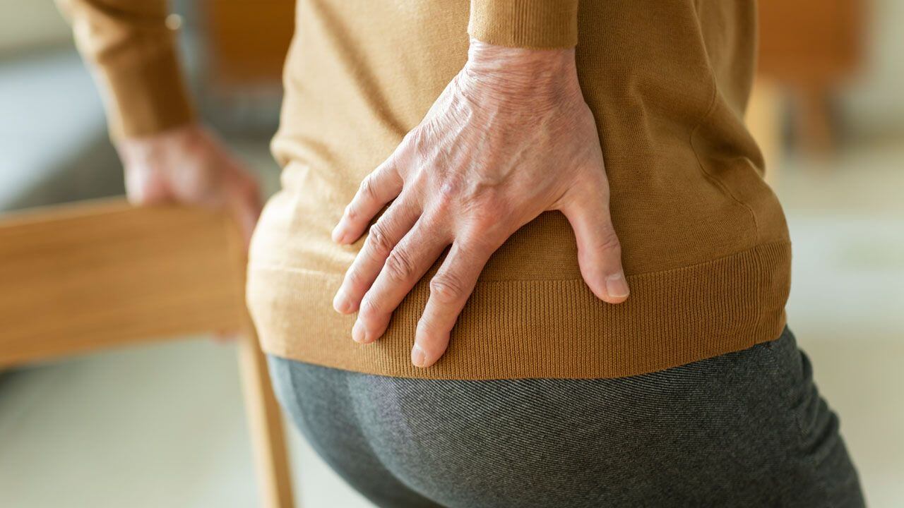 Woman rubbing her hip in pain