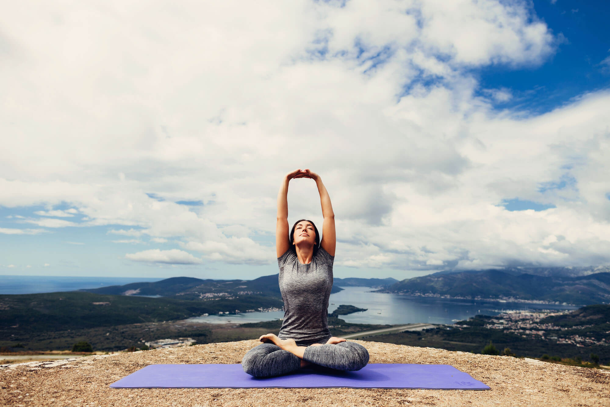 Woman doing yoga on an overlook