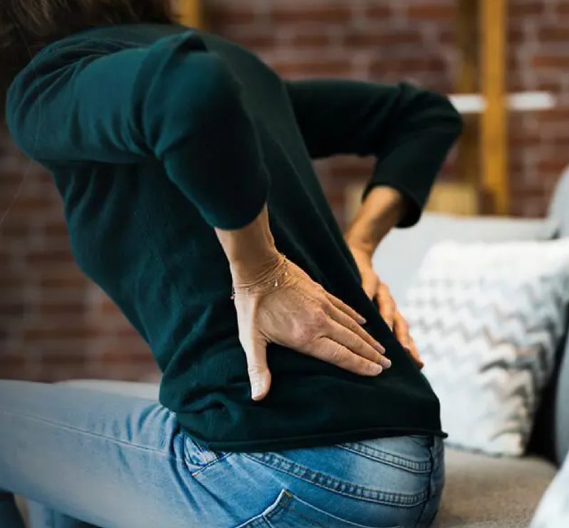 Woman sitting with lower back pain
