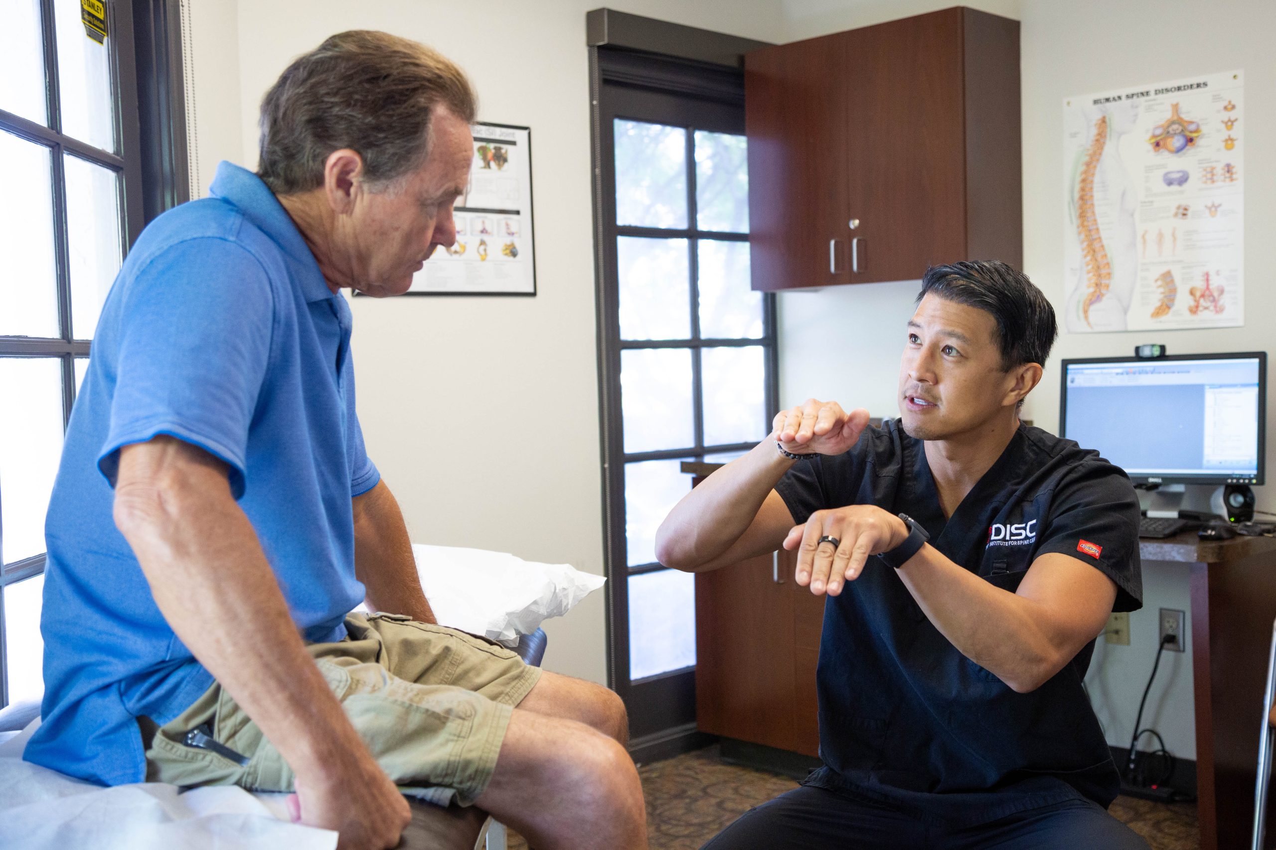 Dr. Wang explaining spine condition to patient